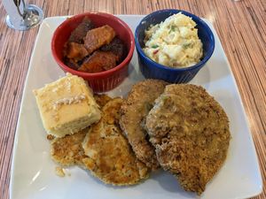 Large plate with crab cakes, fried chicken, potato salad, yams, cornbread at VelTree in Charlotte