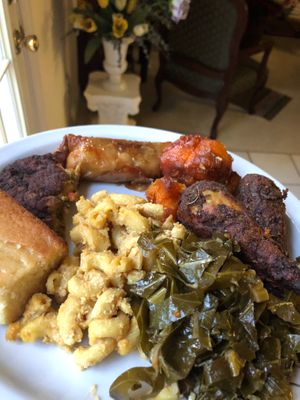 Vegan Drumsticks, Mac and Cheese, Sweet Potato Yams, Collard Greens, Cornbread, Soul Roll, and Half of my dad’s vegan crab cake on a plate! at VelTree in Charlotte