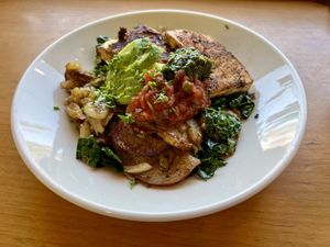 Phoenix Potatoes (the vegan version) - breakfast potatoes with grilled tofu, onions, kale, pico, chimichurri, and avocado.   at Cafe Phoenix in Arcata