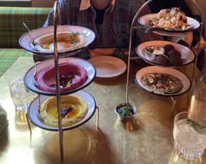 Mezze Trio with cauliflower, falafel and baba ganoush on the right, hummus trio on the left  at NENI in Hamburg