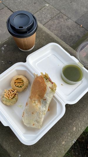 Pani puri w/ green chutney, pickled pakora wrap, masala chai. This is over 60% eaten already - originally there was 6 pani puri & 1 additional wrap. at Snackwallah in Newcastle Upon Tyne