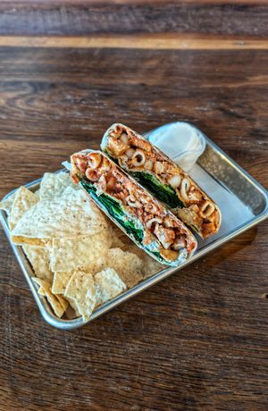 Chick'n Parm Crunch, tortilla crisps, sour cream at Leguminati Vegan Eatery in Orlando