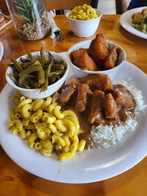 Smother chicken w/gravy on rice with Mac n cheese. Sweet potatoes and green beans at Binge Kitchen in San Antonio
