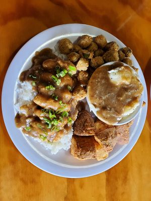 Smothered chicken with fried okra, mashed potatoes, and wedges. at Binge Kitchen in San Antonio