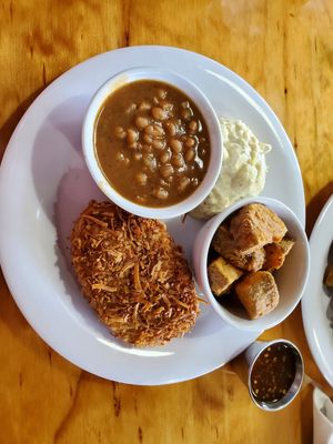 Coconut fried chicken with baked beans, potato salad, and potato wedges. at Binge Kitchen in San Antonio
