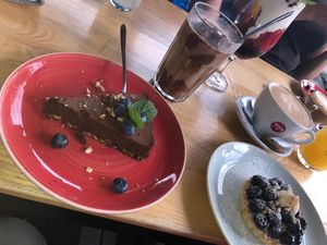 Vegan chocolate cake, a fruit tarte and a vegan iced coffee.  at Strh Cafe & Gallery in Zakopane