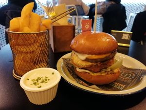 Burger with vegan fried egg, cheese, "pork" party and pineapple at Unity Diner in East London