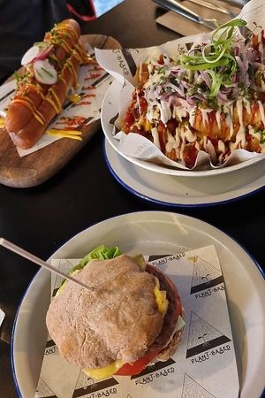 The classic cheese burger (with a gluten-free bun), and a vegan version of a hot dog (with a gluten-free brioche) at Unity Diner in East London
