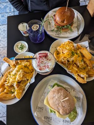 Beyond burger (gluten-free) and Redifine Meat burger, loaded cheesy fries, 'I love Ewe' and 'Piers Morgan's tears' cocktails at Unity Diner in East London