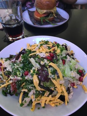 Caesar salad & gf surge burger in the back  at Unity Diner in East London
