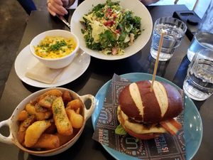 Burger with bakon, chunky fries, mac n cheese, chicken ceasar salad. at Unity Diner in East London