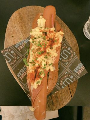 Supreme dog (Moving Mountains sausage wrapped in bakon, mac and cheeze, mayo, greens)  at Unity Diner in East London