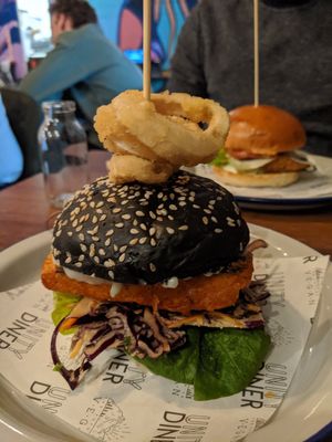 Tofish stack in the front, chickken bruger in the back at Unity Diner in East London