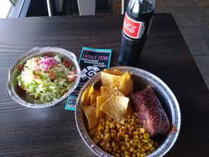 Tamale with sides of corn and tostada at The Tamale Store in Phoenix