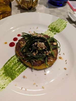 Medaglione di legumi con agretti e pesto al limone at Shakti Food in Brescia