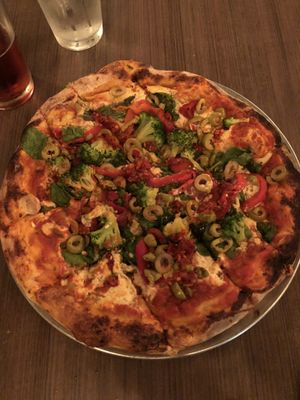 Veggie pizza, made with vegan ricotta and topped with calabria peppers at Firepit in Atlanta