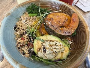 Superbowl Salad: superfood salad of mixed greens, pumpkin, quinoa, broccolini, goji berries & seed mix, served with avocado, house made turmeric, ginger sauerkraut & green tahini   at Nourished in Avalon Beach