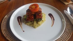 Vegan Ribs (Grilled marinated tempeh on barbecue sauce served with garden mixed salad and mashed sweet potato) at Pissari Bali Cafe in Ubud