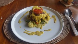 Vegan steak (grilled red kidney bean patties on onion curry sauce with sautéed vegetables and sweet potato mash) at Pissari Bali Cafe in Ubud