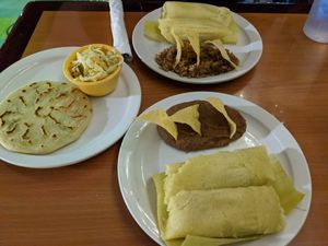 Sweet corn tamales, jalapeno & bean papusa (wow!!), sides of beans and casamiento (bean and rice mix). The papusa includes pickled slaw. at Fernanda's Salvadorian in Cathedral City