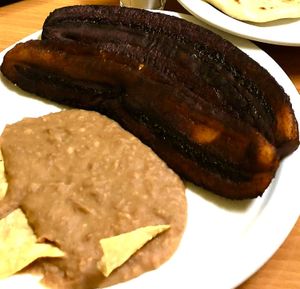 Sweet fried plantains with refried beans and corn chips. at Fernanda's Salvadorian in Cathedral City