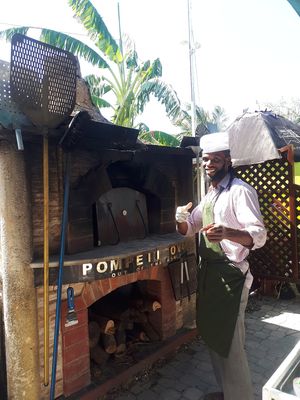Stephen and the oven at Lion's Share Cafe in Bridgetown