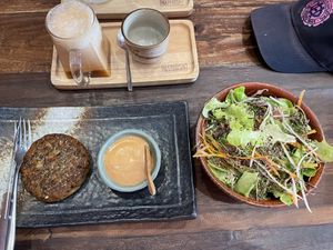 The bunless combo, 350 baht. Consists of a patty with sauce, a side salad, and a drink (I went with a chai tea).  at Kunda Vegan Vegetarian in Chiang Rai