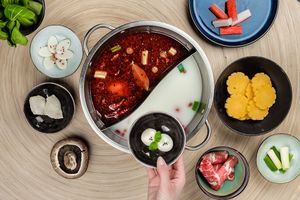 Hot pot is a traditional Chinese cooking method? It is prepared with a simmering pot of soup stock at the dining table, containing a variety of meats, vegetables and Asian ingredients.  at Hot Pot Republic in Copenhagen