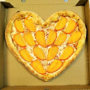 Hurmapizza in the shape of a heart. Vegan cheese (mix from 4 items)+ tomato sauce + sweet hurma + sesame at The Slice Pizza in Moscow