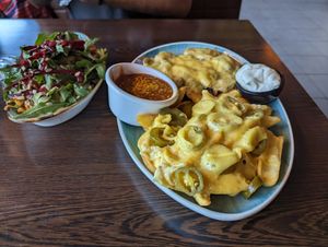 Mushroom cheese schnitzel with cheesey fries and a salad at Apple & Eve in Hamburg