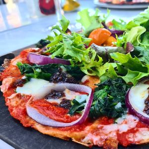 600 kcal pizza (with hole on the middle) with salad on the middle. Vegan cheese.  Vegan menu available.  6 or 8 diffrent  pizzas to chose from and 2-3 diffrent starters. at Pizza Express - Paddington in West London
