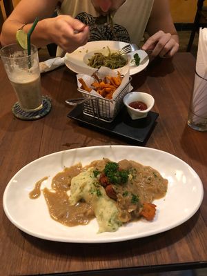 My bangers and mash and my boyfriends pesto pasta with a side of the most delicious sweet potato fries  at The Vegan Table in Phuket