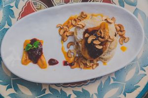 Pancakes with flambé bananas, strawberries and cashews! at The Vegan Table in Phuket