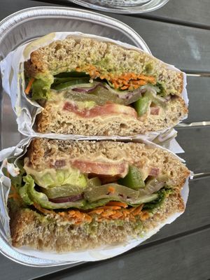 Hummus & avocado spread, carrots, lettuce, tomatoes, onions, pickles and cucumbers.   at Sprouts Farmers Market - Ballancroft Pkwy in Charlotte