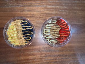 Blueberry pineapple vs strawberry banana açaí bowls at Rhythm & Beets Juice Cafe in New York City