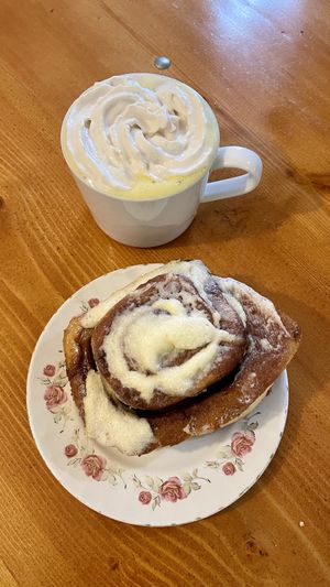 Turmeric latte w coconut whip and a huge cinnamon roll  at Fern Cafe and Bakery in Victoria