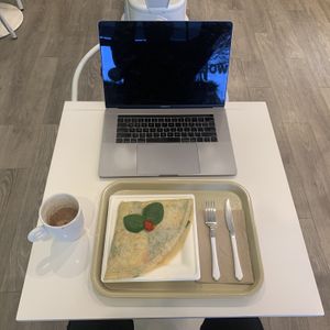 Vegan crepe, latte, cafeteria tray, 2-top table (MacBook Pro 15” for scale) at Dulce Crepes in Fairfax