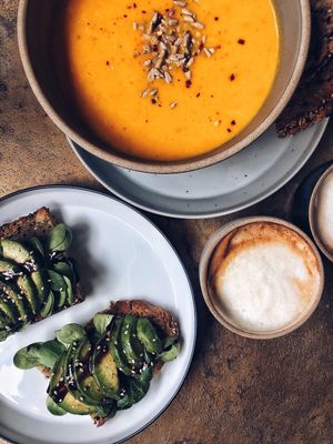 Avocado bread and carrot ginger soup with oat cappuccino at Balance Deli in Frankfurt