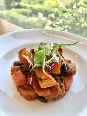 Carrot Aubergine Puttanesca with butternut wedges  at Eat Well Restaurant in Dubai