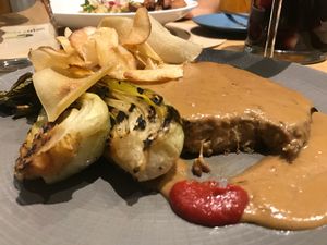 Seitan streak with bokchoy, and cassava chips! Amazing!!!  at Veganapati in Lisbon
