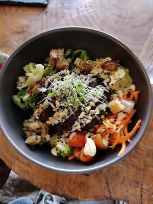 Bowl with hamburger on top at Apuro Vegan Bar in Porto