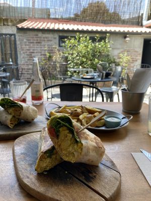 Lazy burrito with fries and a doggy burrito in the back  at Apuro Vegan Bar in Porto