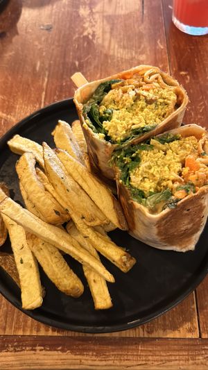 Scrambled tofu, sausages and carrots inside a burrito   at Apuro Vegan Bar in Porto