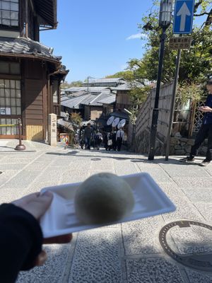 Sitting on the bench outside the shop  at Tofu Manjyu Okutan Kiyomizu in Kyoto