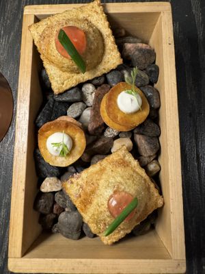 Amuse-bouche: fried onion ravioli and carrot cheese cracker  at L'Orygine in Quebec