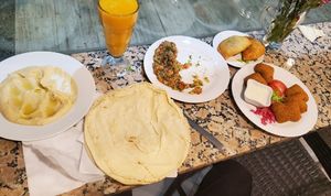 Hummus, baba ghanoush, a red pepper dip, spinach fritters, falafel at Abou Tayssir in Tangier