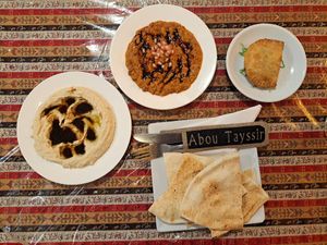 Flat bread, pomegranate hummus, muhammara, borak. at Abou Tayssir in Tangier