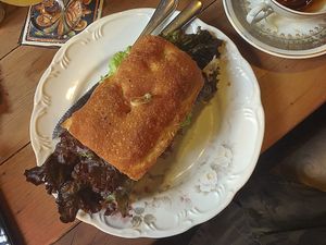 Sanduíche Vegano no pão de abóbora com caponata, tomate seco e creme de Grão de Bico e azeite  at Agridoce in Porto Alegre