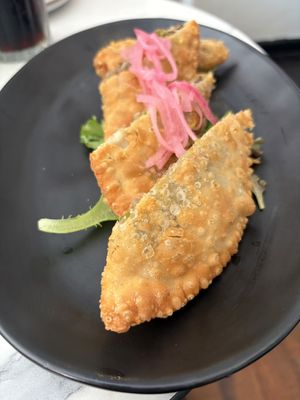 Vegetable empanadillas are a must get.   at Cafe Berlin in San Juan