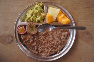 Fresh fruits, guacamole, and millet pancakes at Sadhana Forest in Maralal